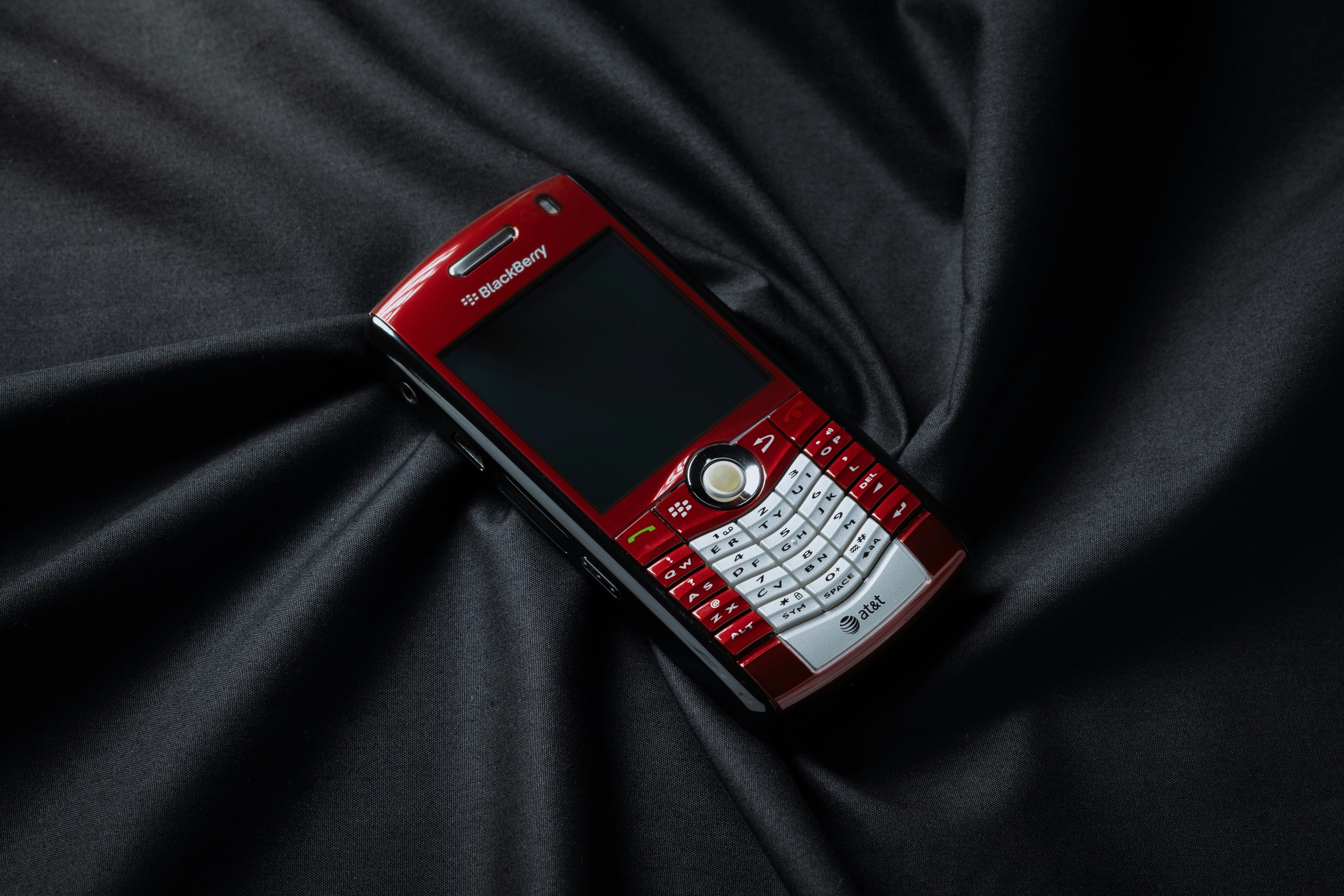 Red mobile phone on black cloth