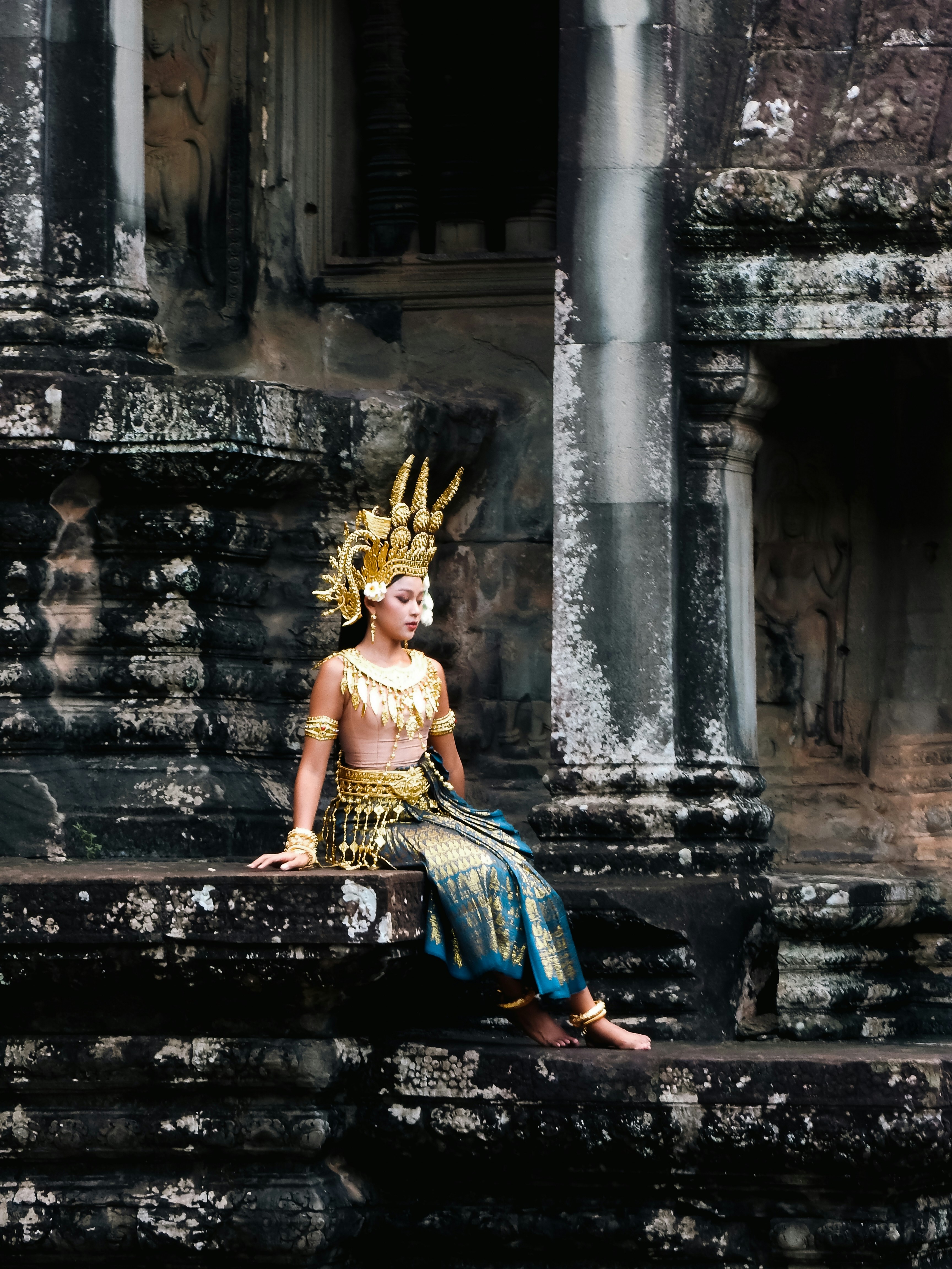 A woman in a costume sitting on some steps