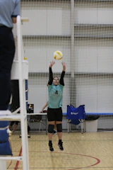 A person jumping up to hit a volleyball
