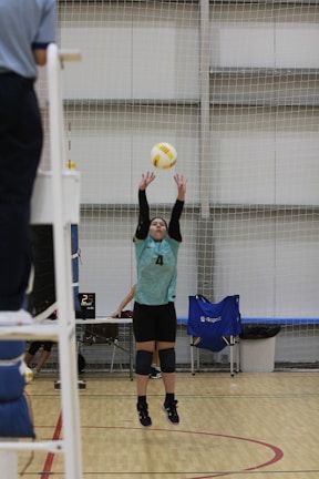 A person jumping up to hit a volleyball