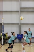 A group of young women playing a game of volleyball