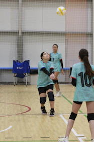 A group of young women playing a game of volleyball