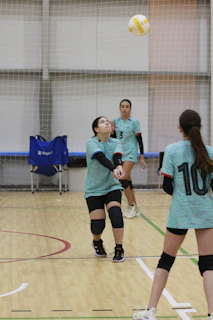 A group of young women playing a game of volleyball