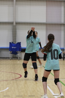 A group of young women playing a game of volleyball