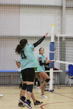 A group of young women playing a game of volleyball