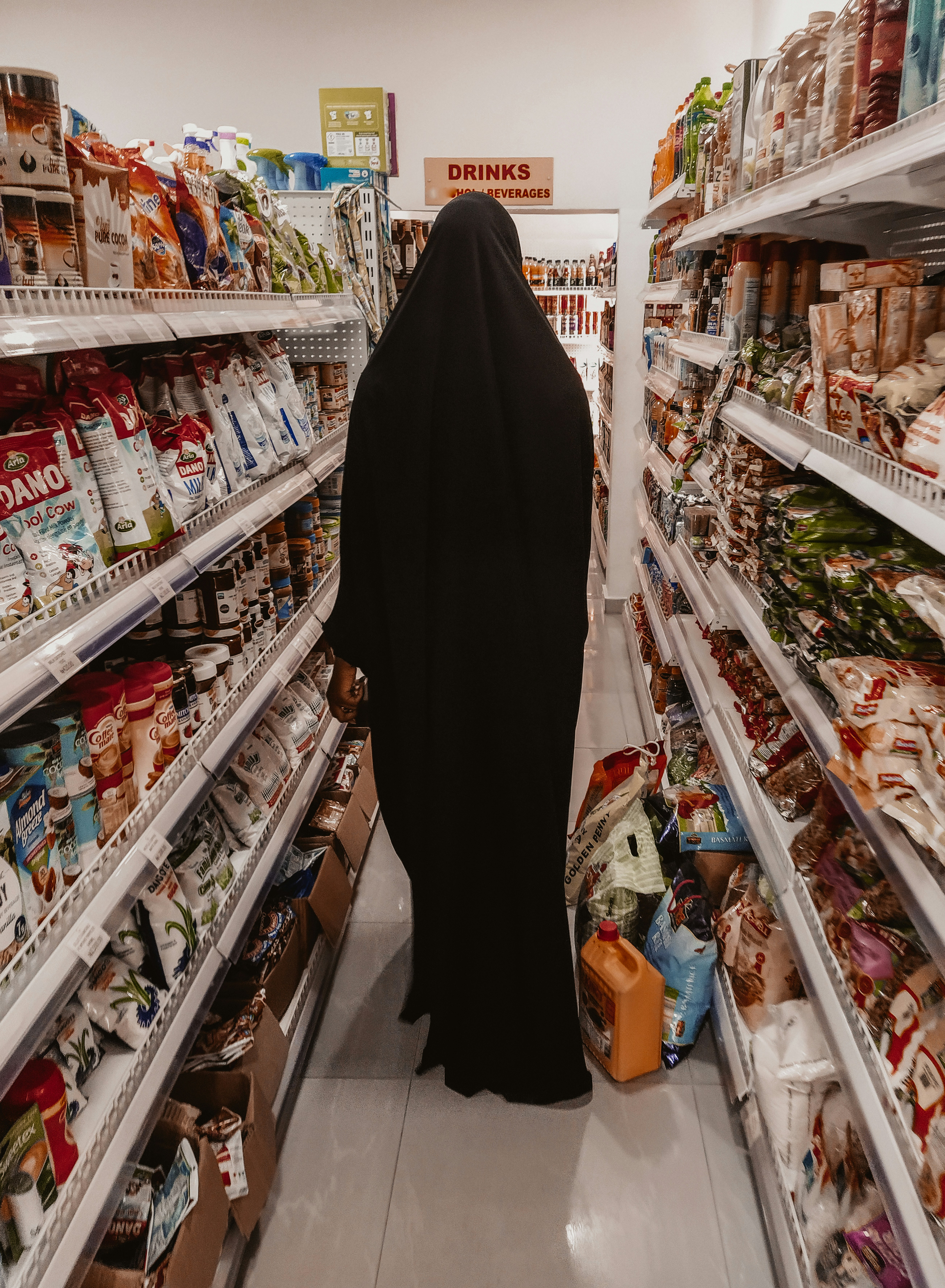 A woman shopping for abayas in a store