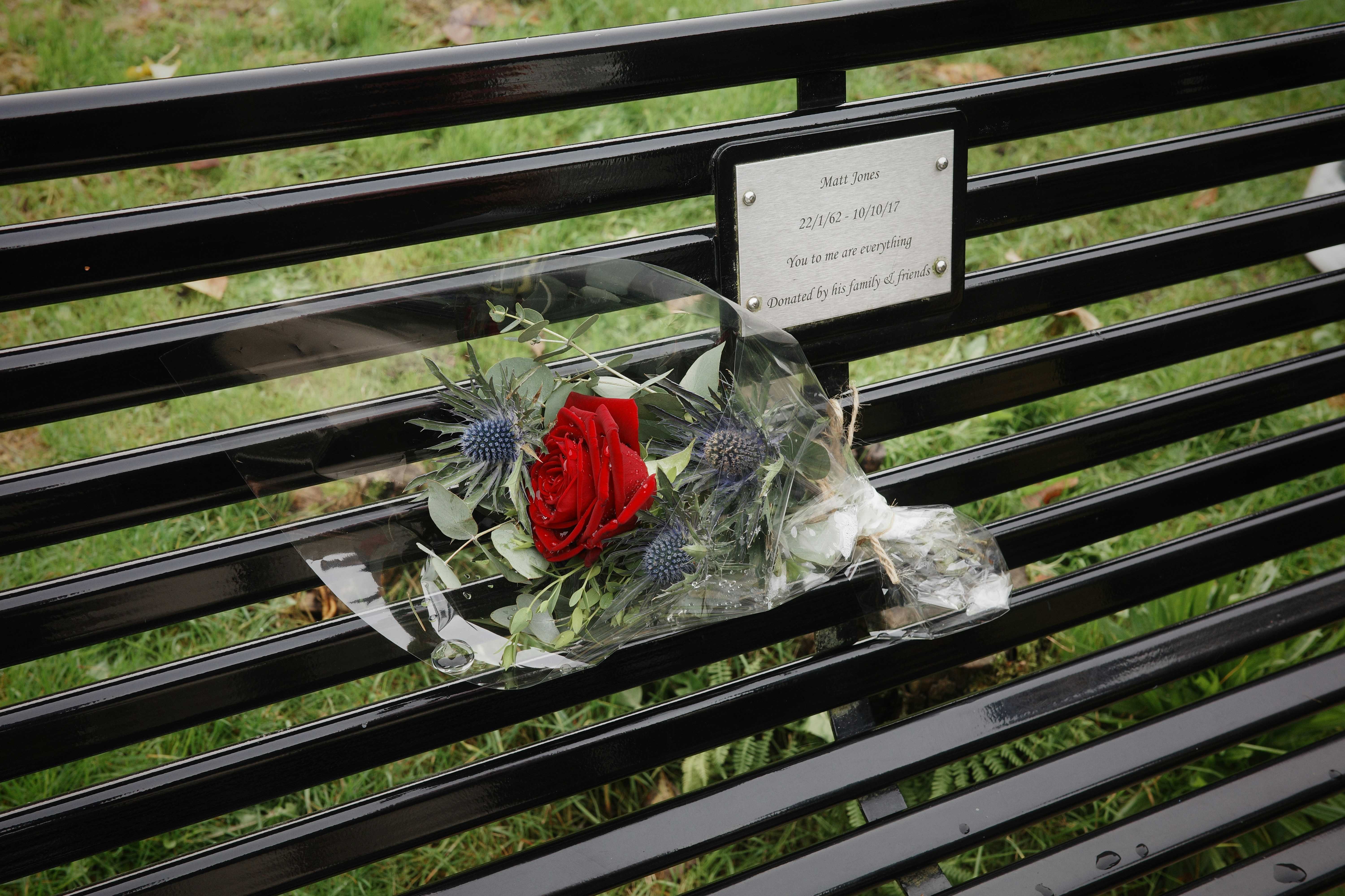 A memorial is placed on a park bench