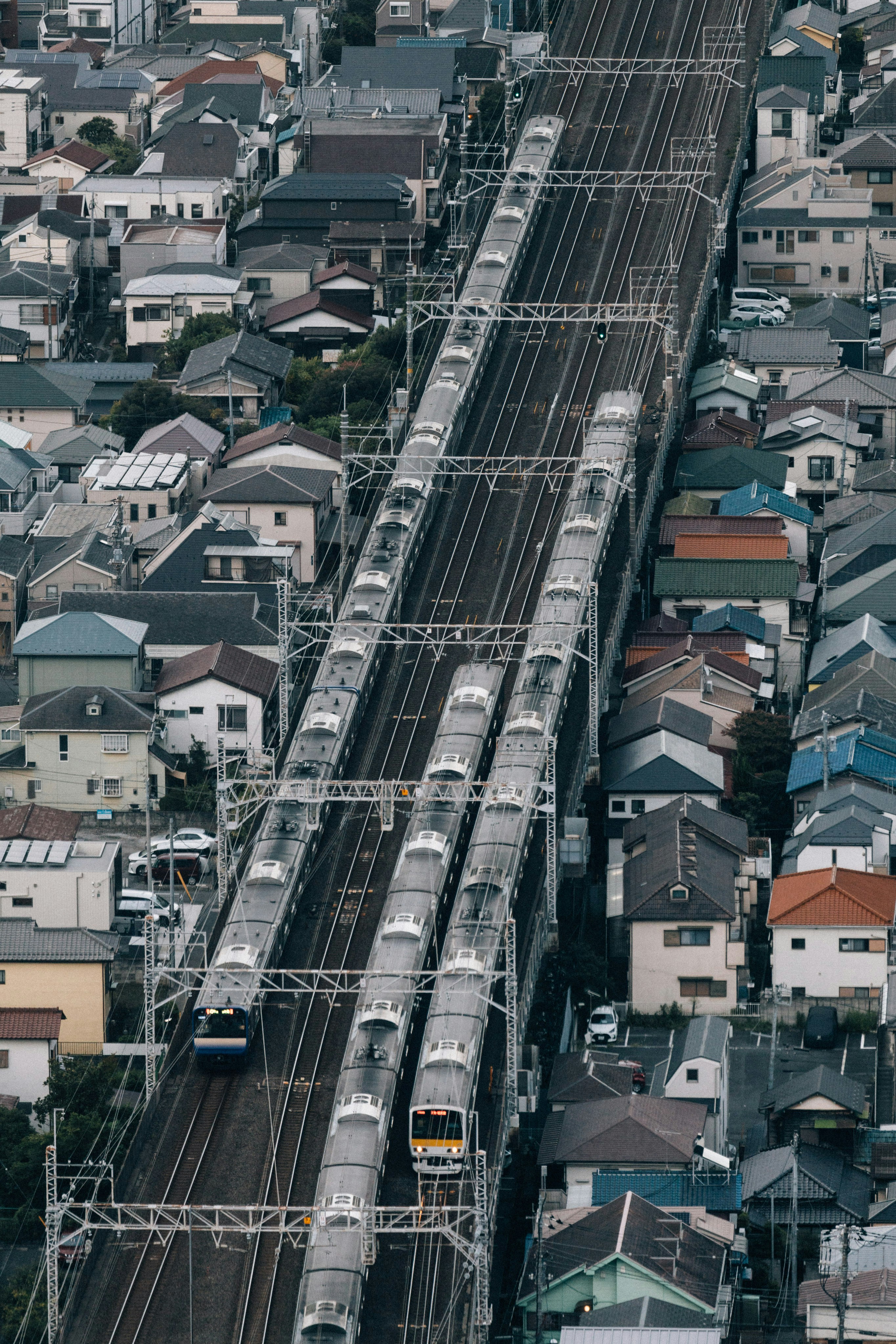 A train traveling through a city next to tall buildings photo – Free ...