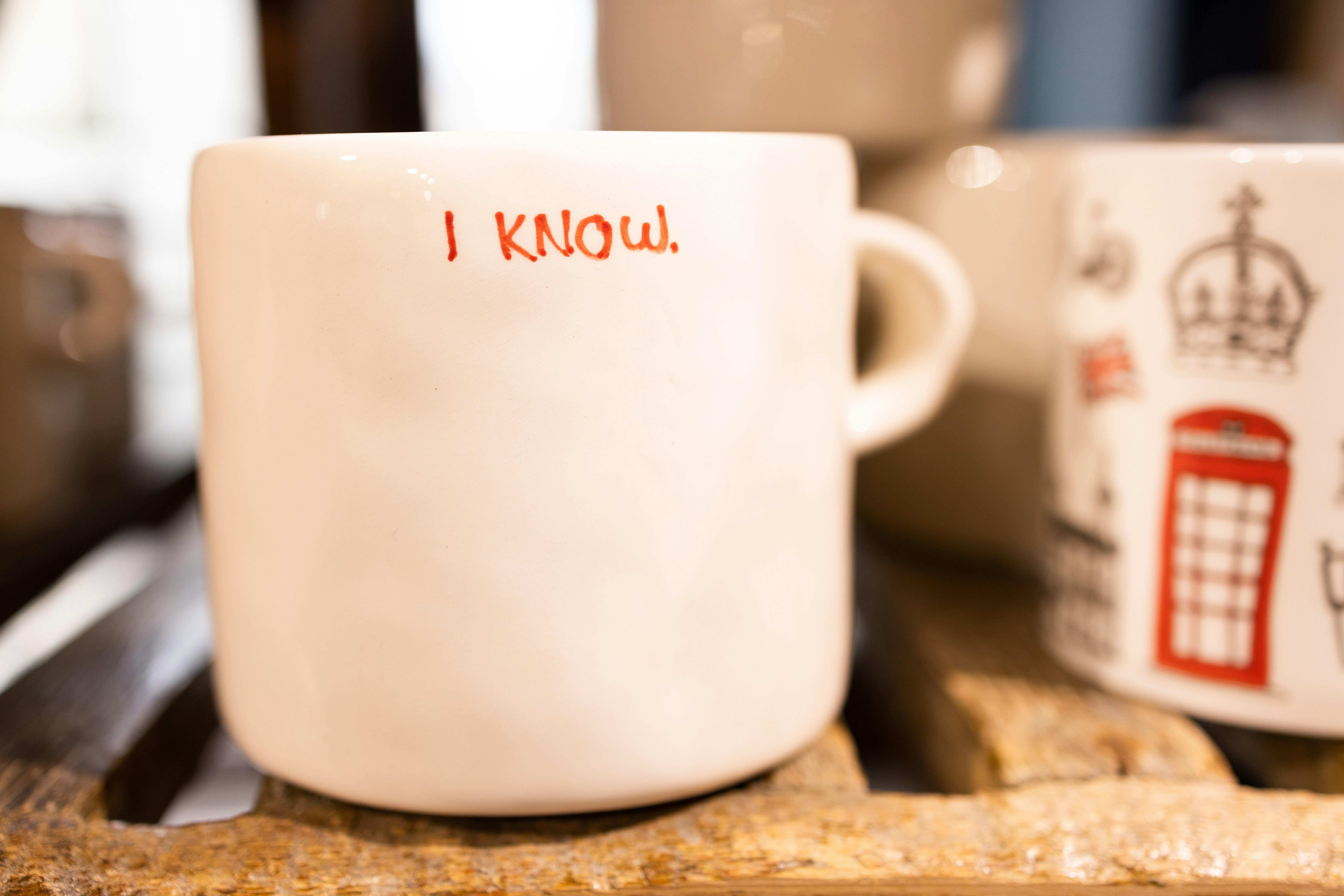 A couple of coffee cups sitting on top of a wooden table