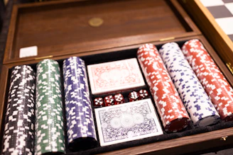 A wooden box filled with lots of playing cards
