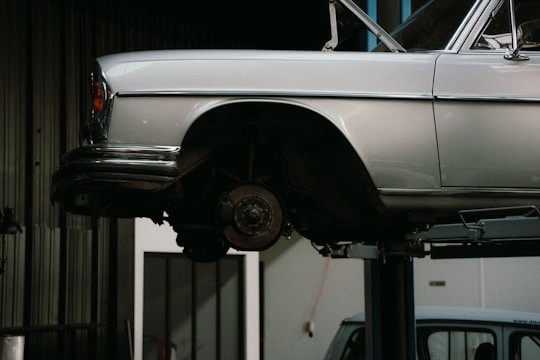 Car elevated on lift for tire rotation service