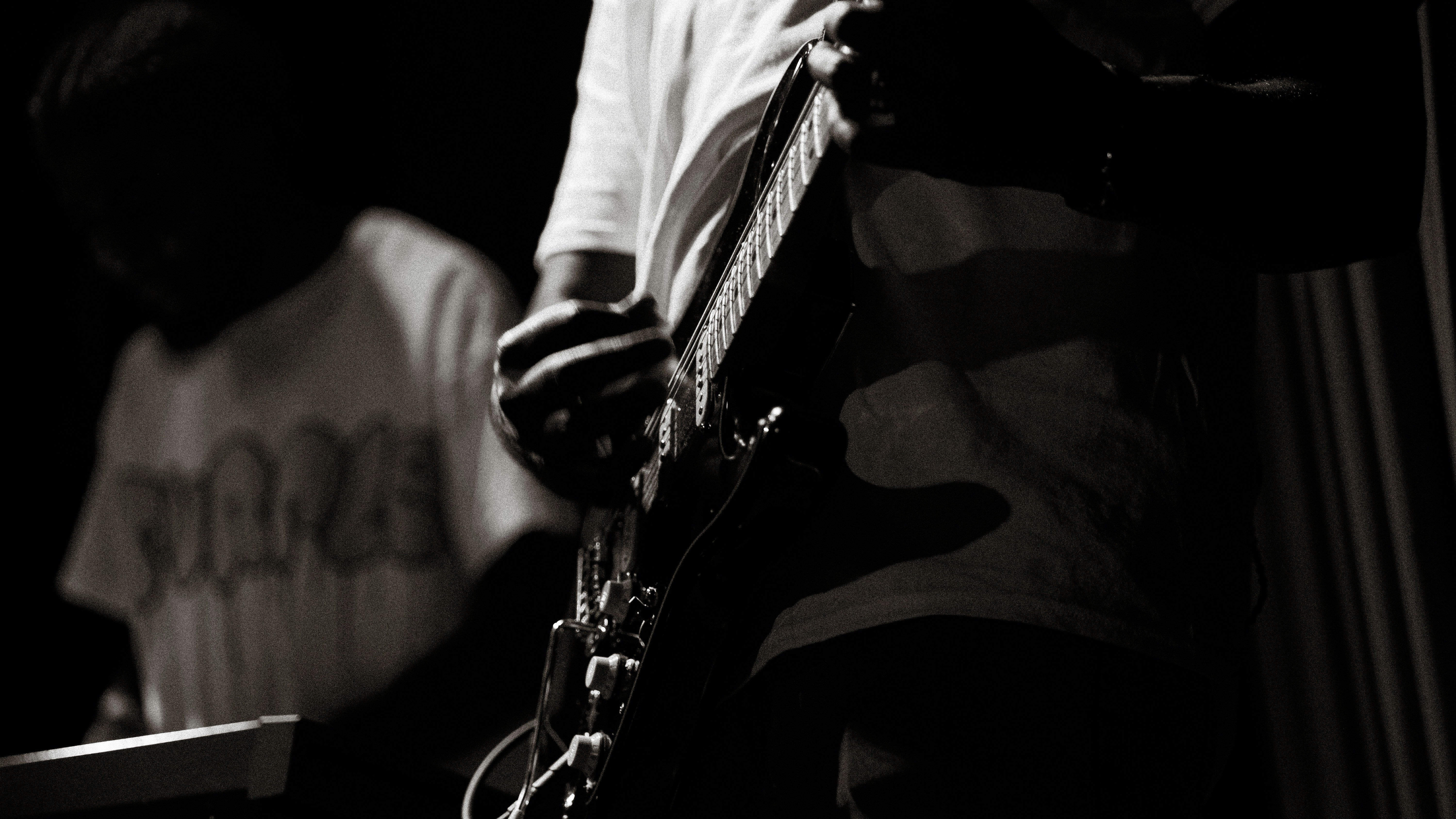 A black and white photo of a man playing a guitar