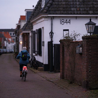 A person riding a bike down a street