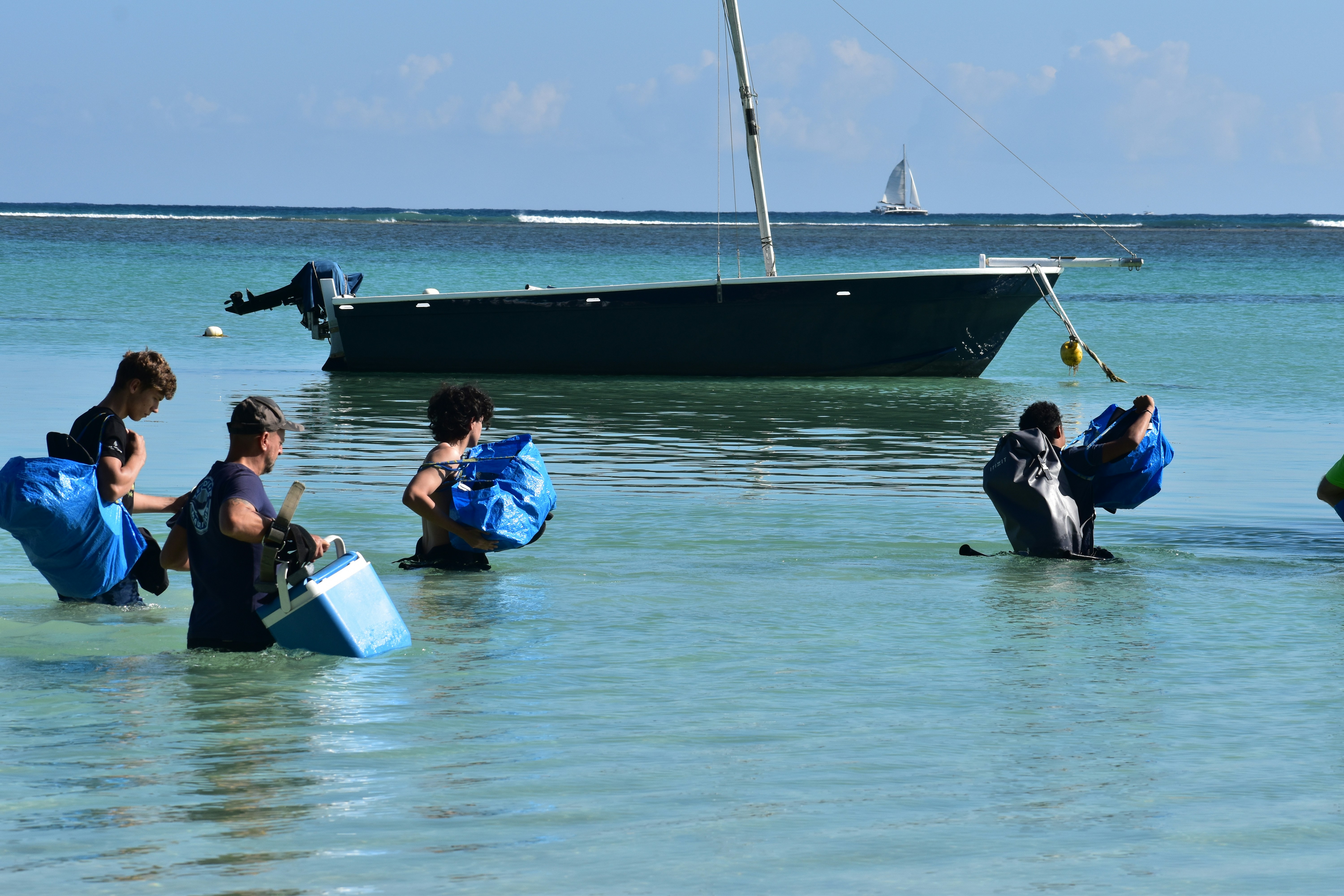 Visitors snorkeling in the clear waters of Orange Bay
