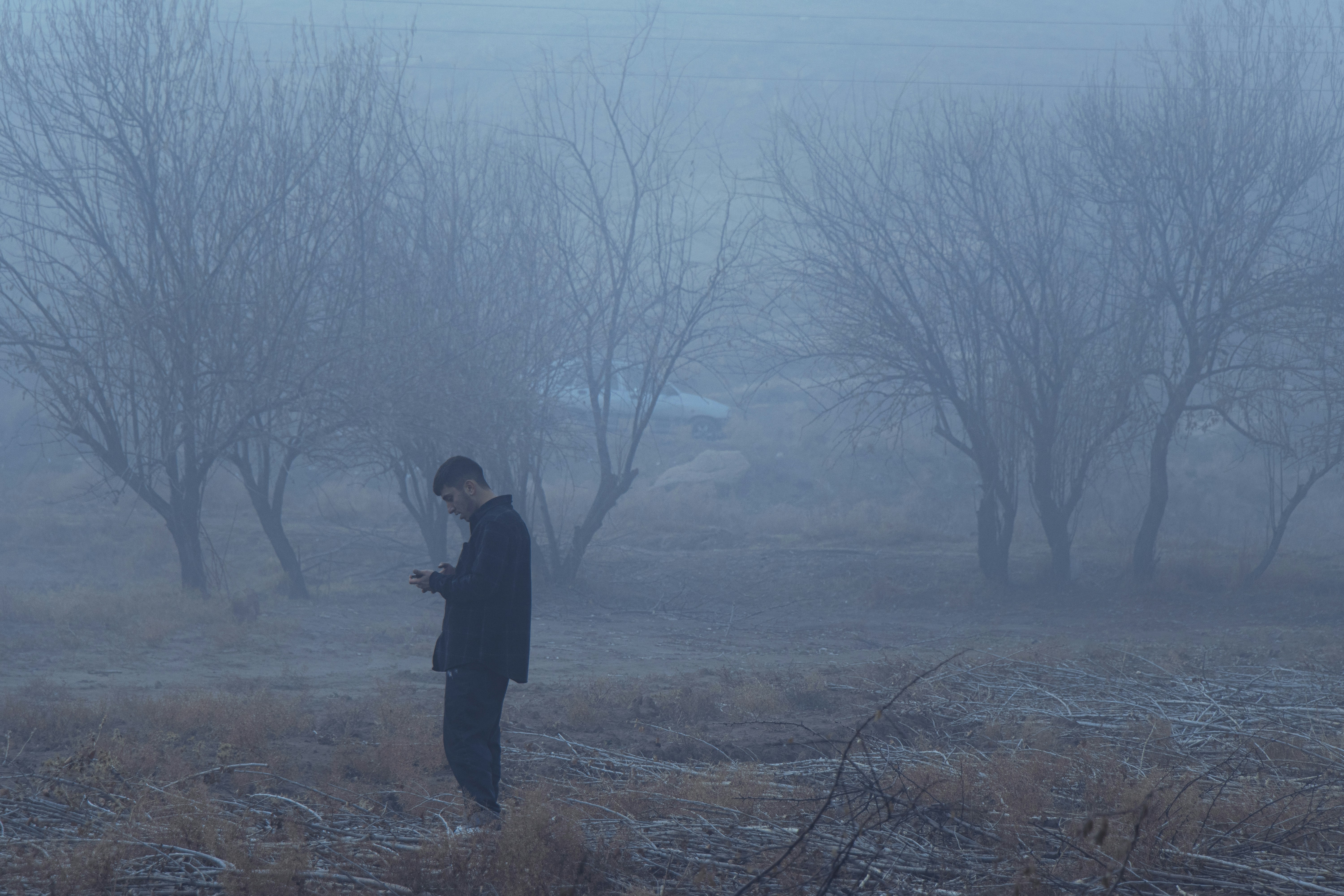 A man standing in a field in the fog