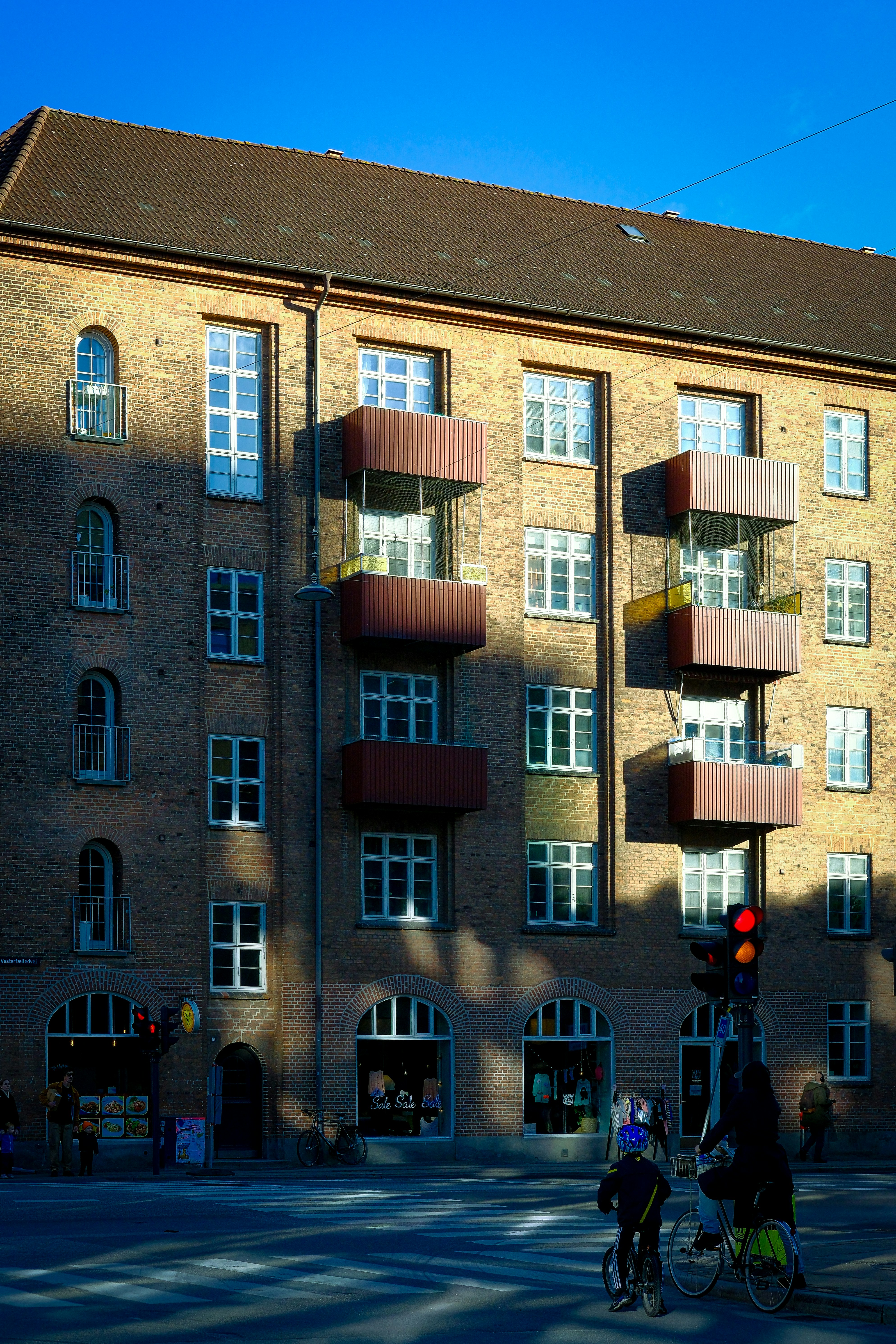 A tall brick building with balconies on top of it