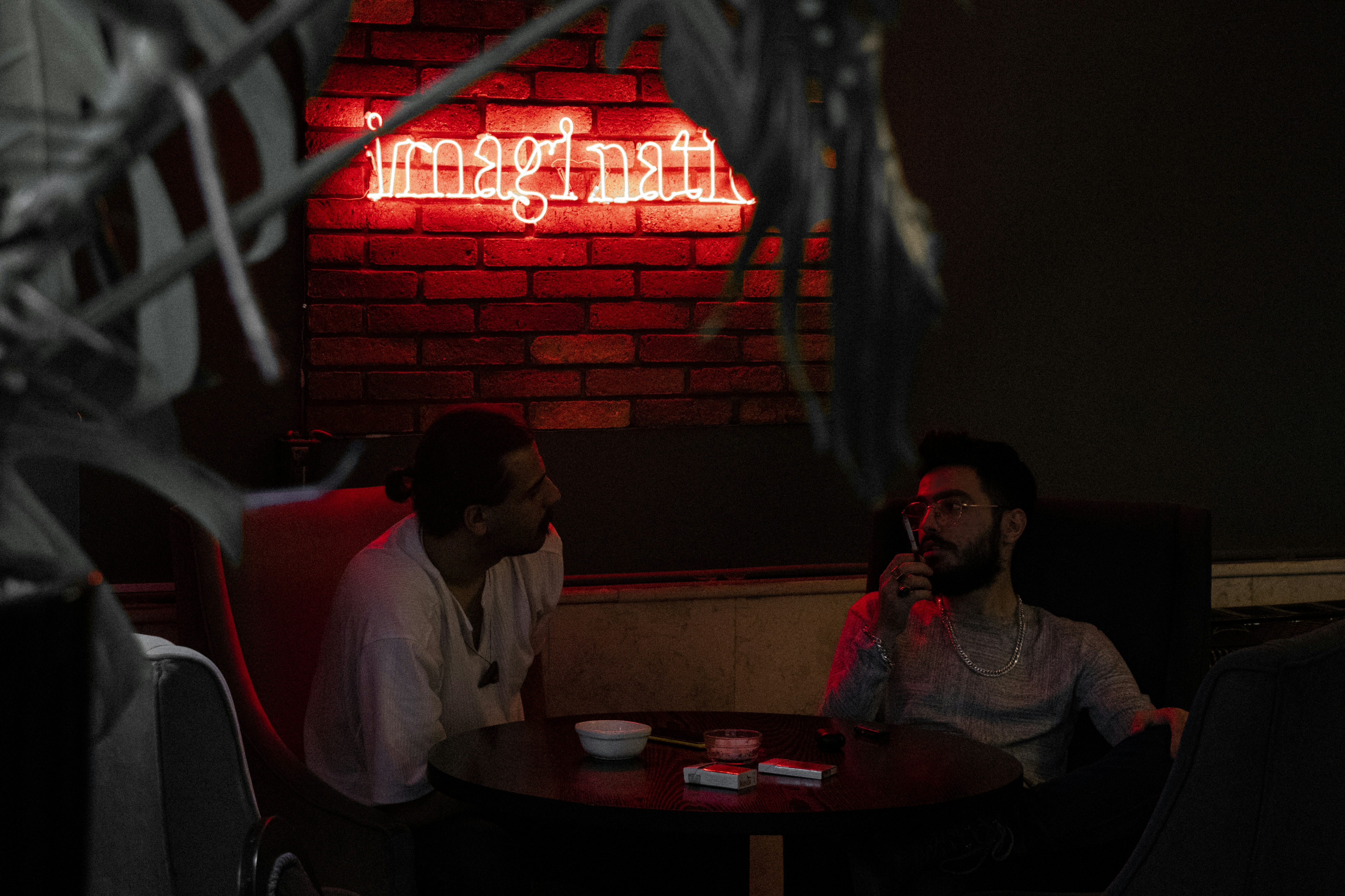 A couple of men sitting at a table in a restaurant