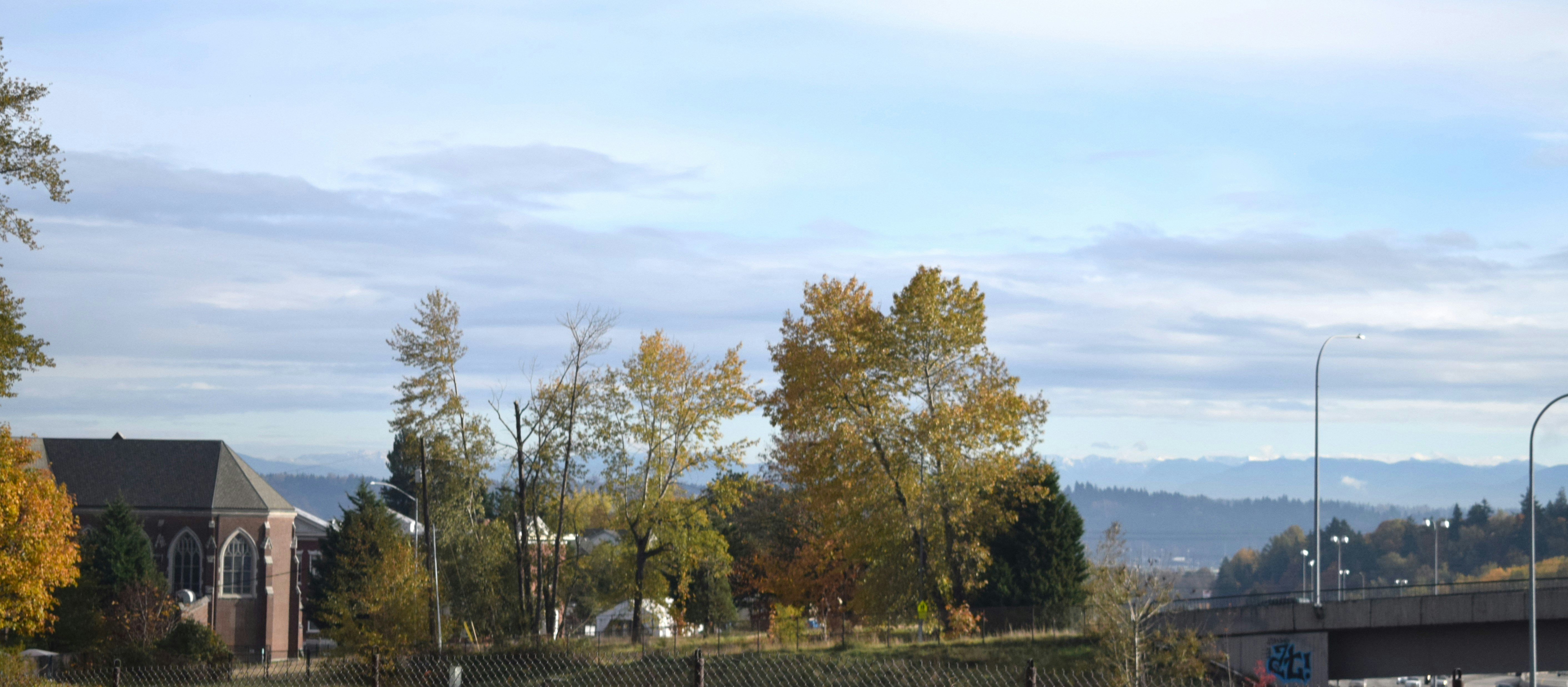 A blurry photo of a street with a fence