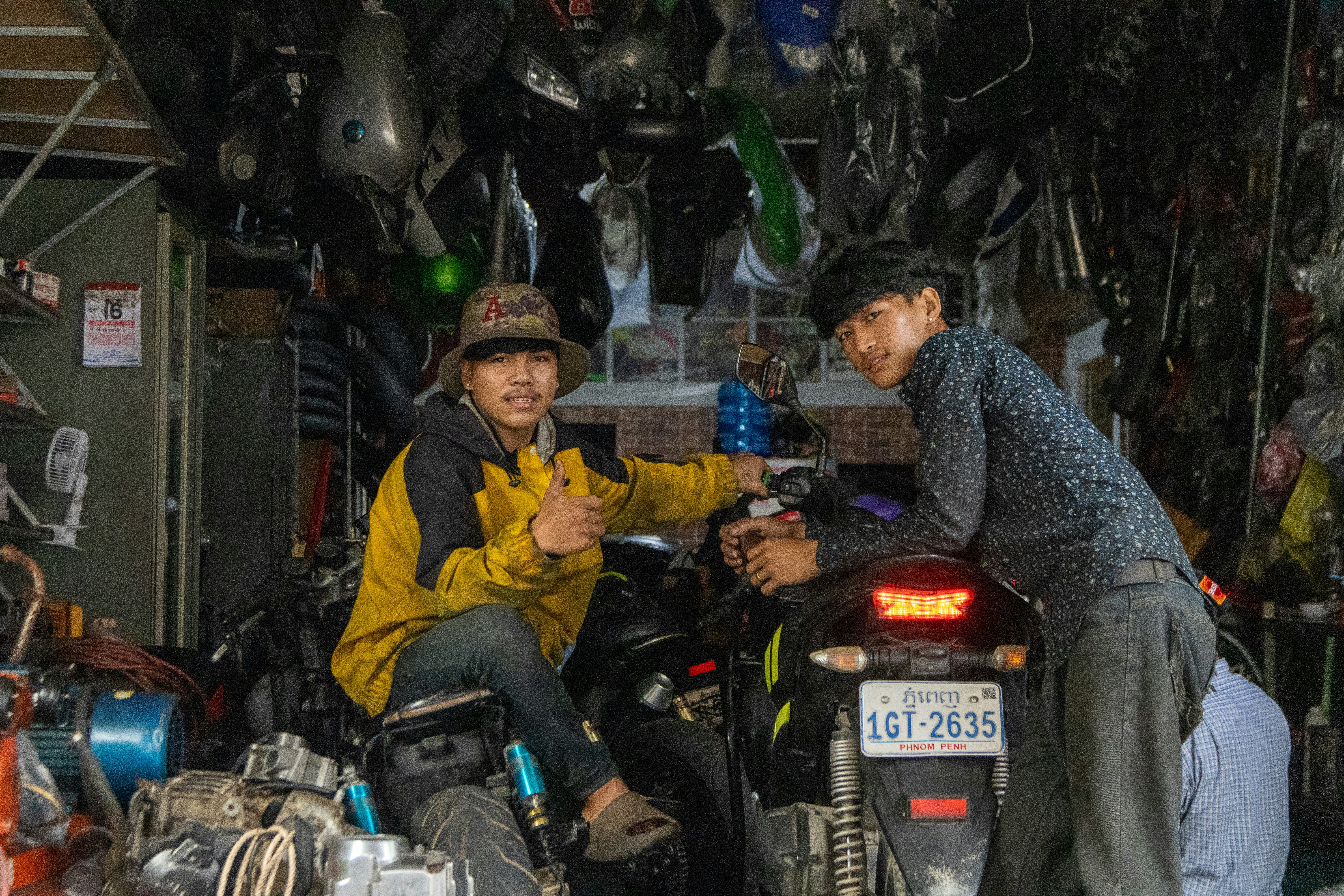 A couple of men riding on the back of a motorcycle