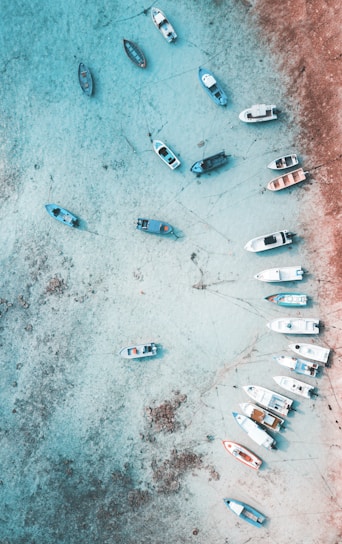 A group of boats sitting on top of a sandy beach