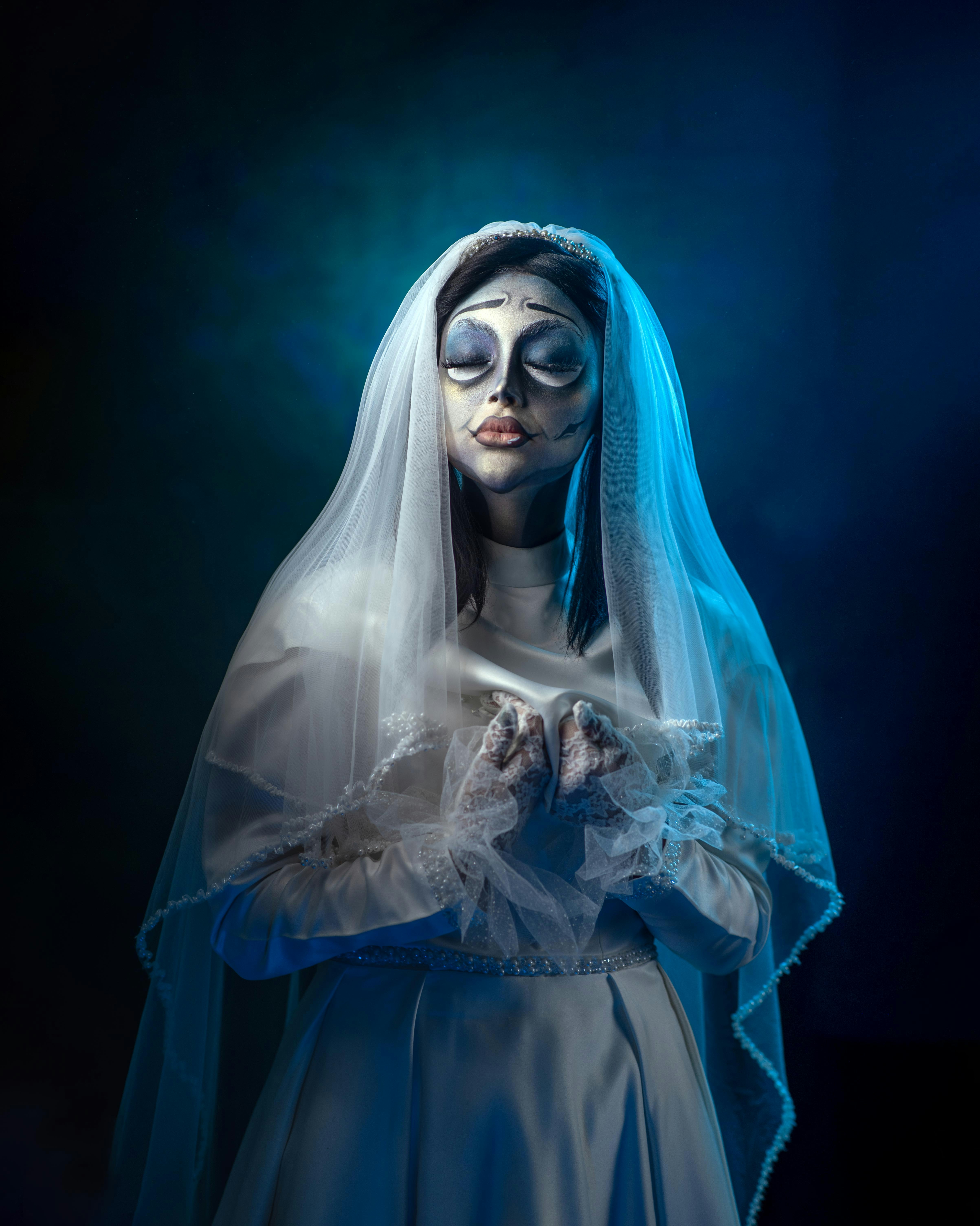 A woman dressed as a bride in a blue dress