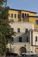 A large building with cars parked in front of it