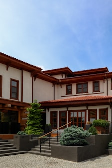 A large white house with a red roof