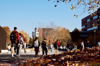 A group of people walking down a street