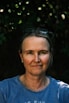 A woman wearing a blue shirt and sunglasses