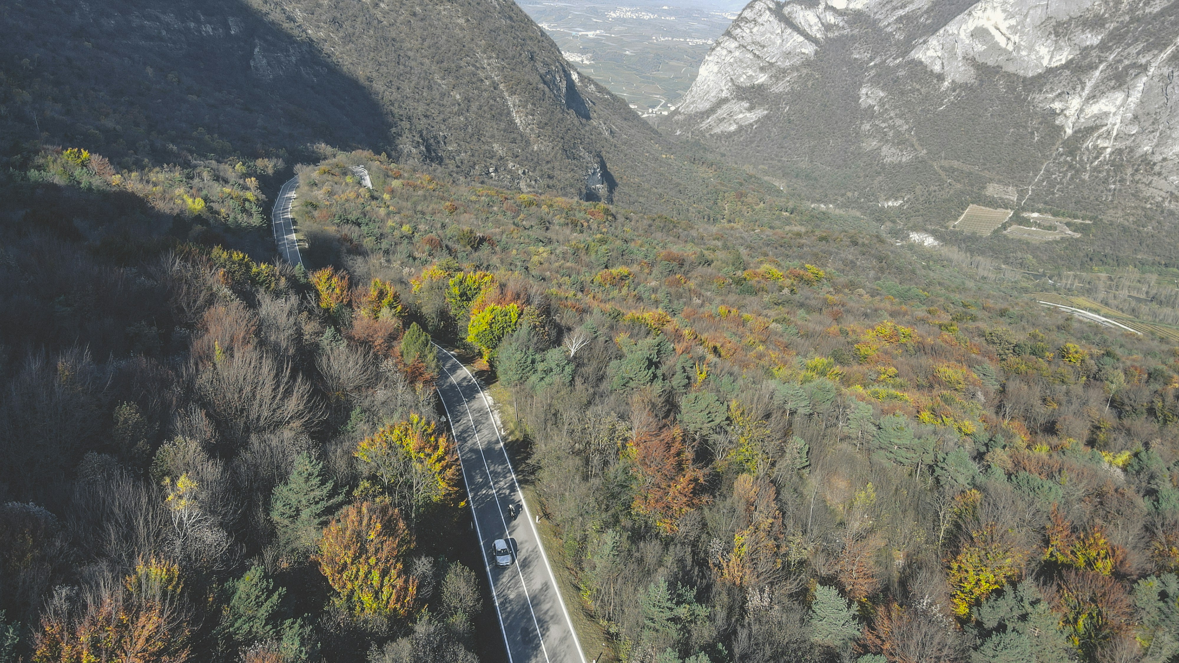 An aerial view of a winding road in the mountains