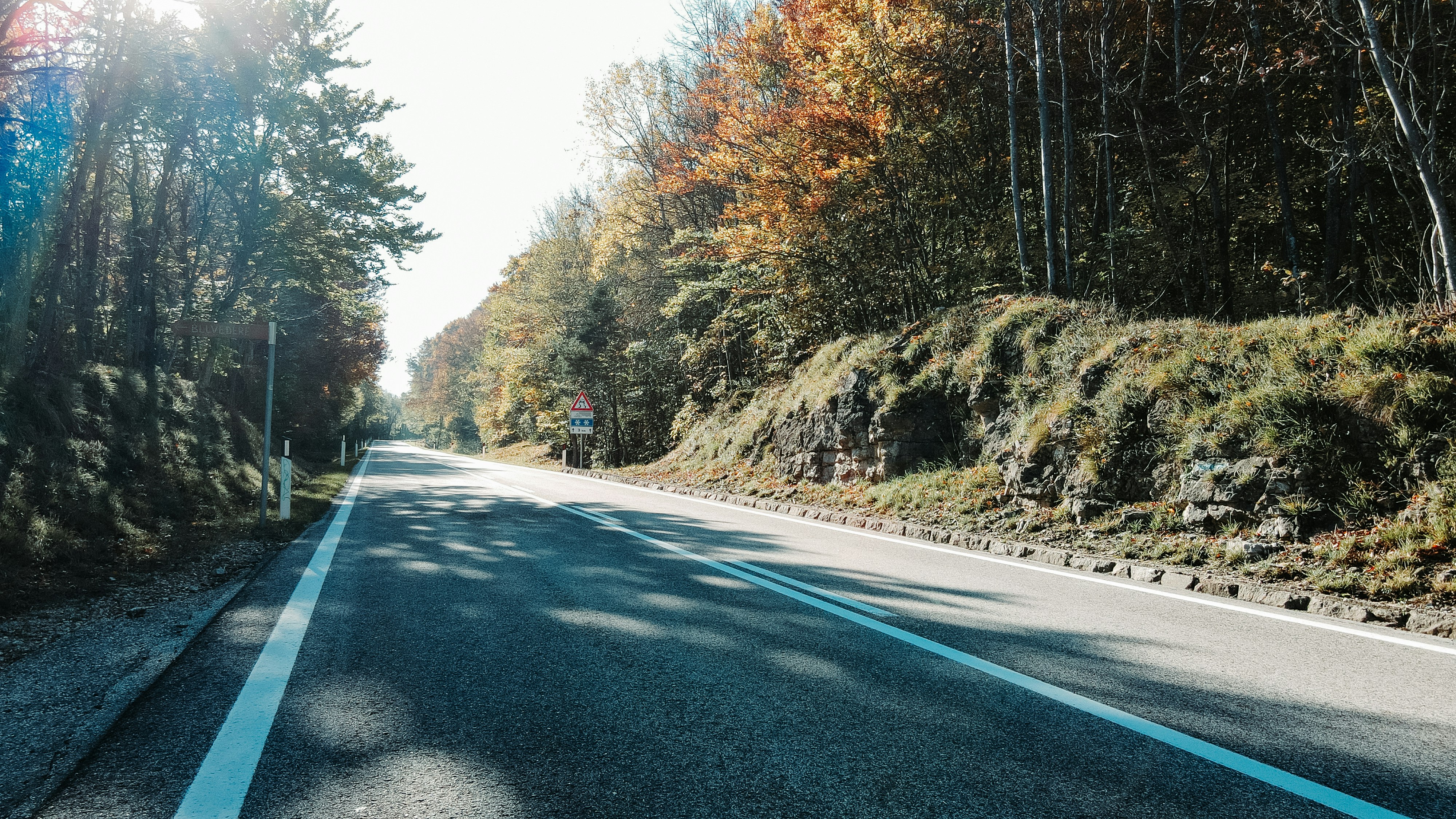 A person riding a skateboard down a road