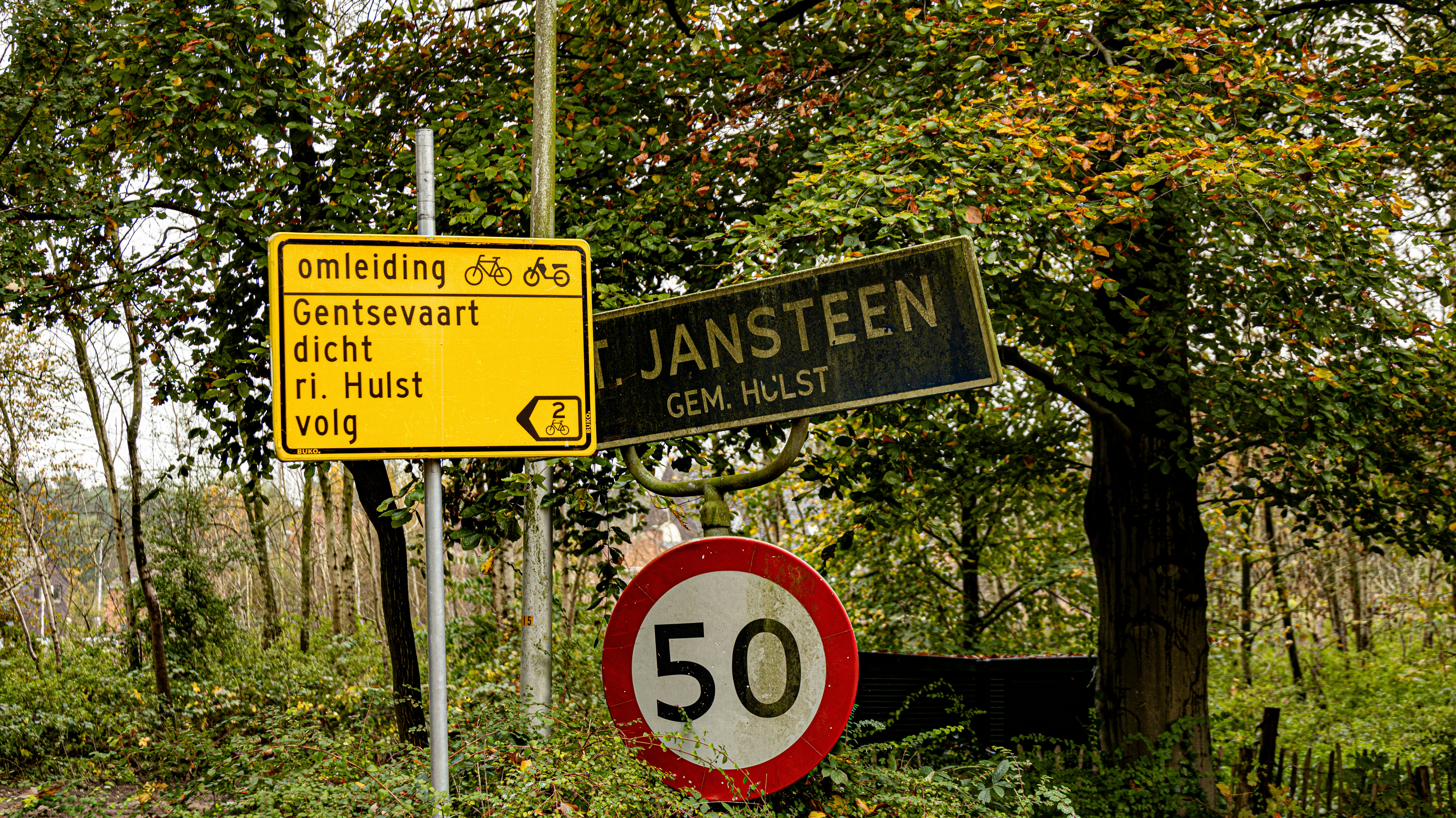 A couple of street signs sitting on the side of a road