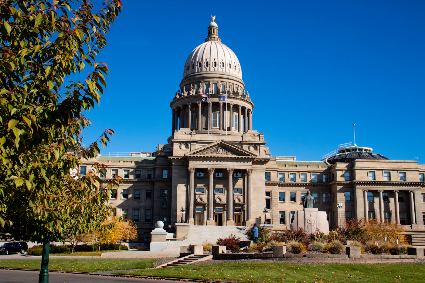 The Idaho State Capitol building in downtown Boise beneath a clear blue sky