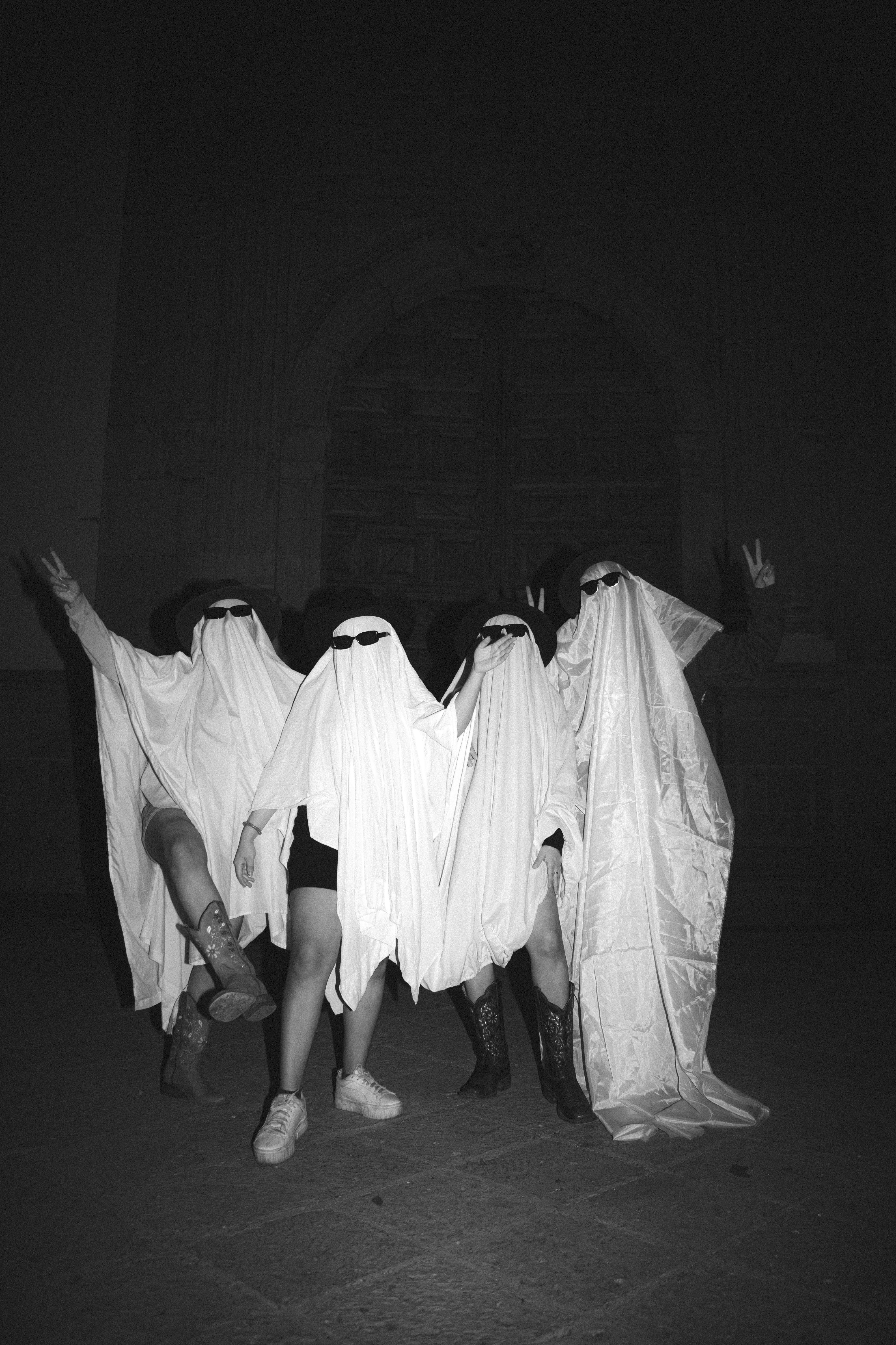 A group of people dressed in ghost costumes