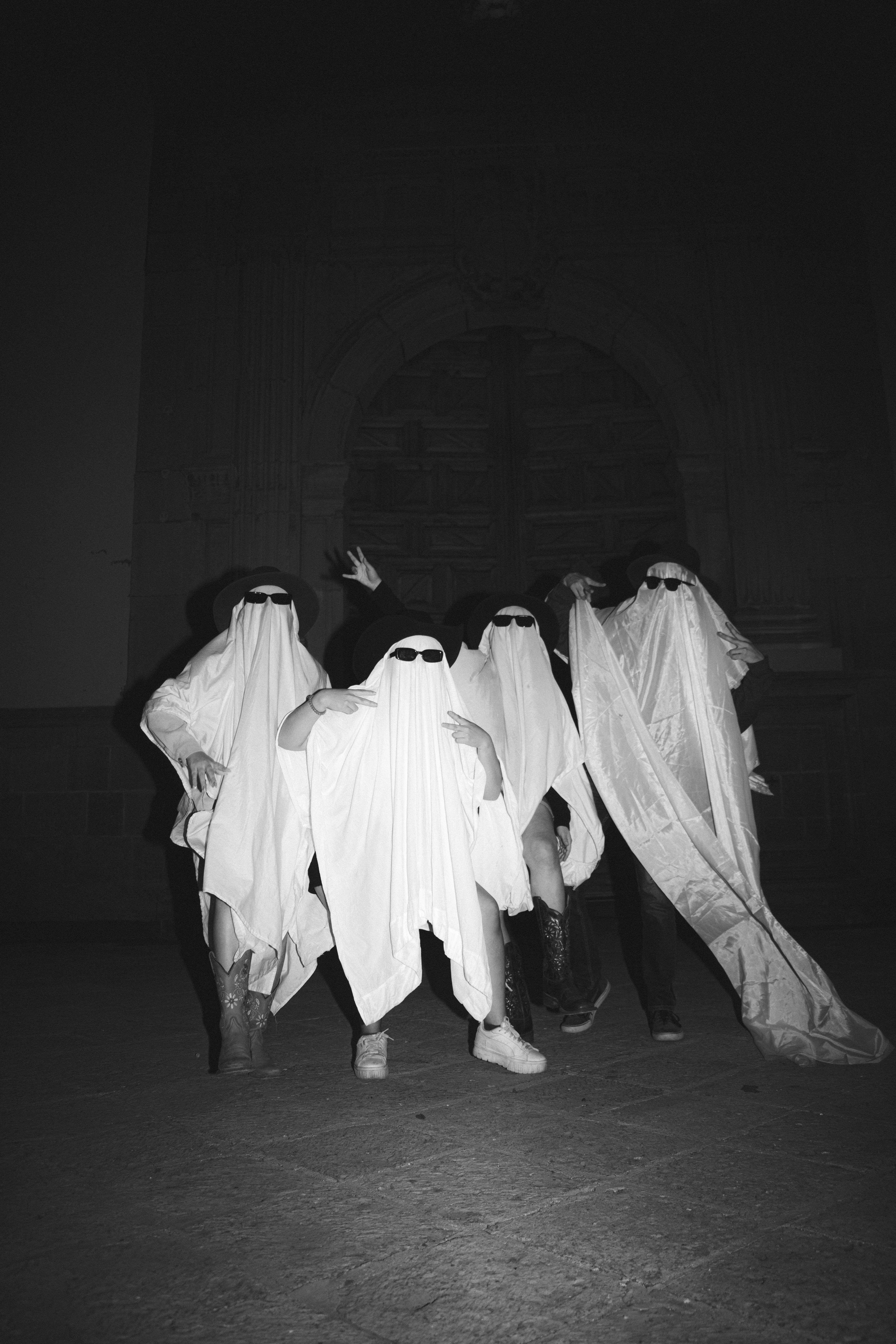 A group of people dressed in ghost costumes
