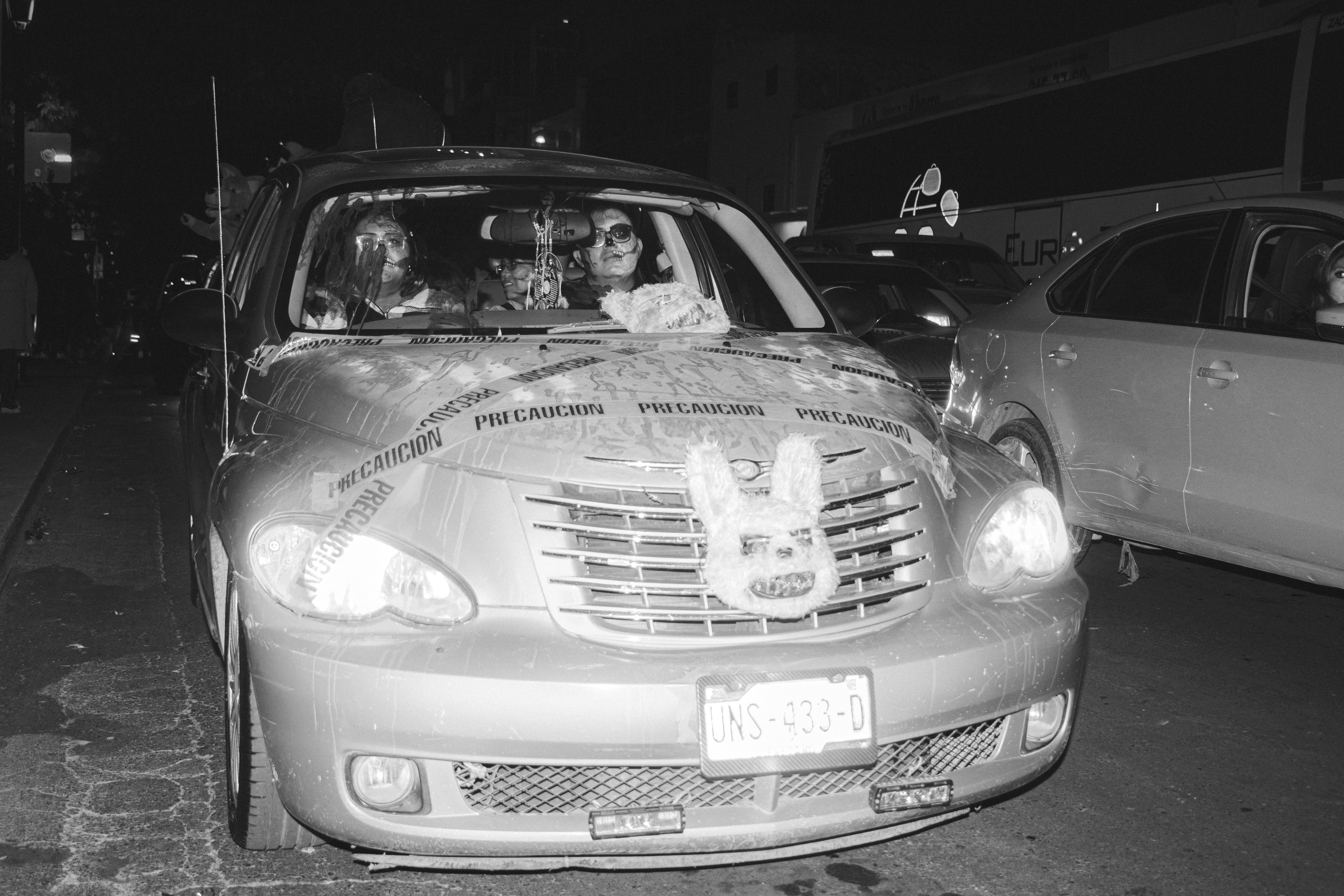 A black and white photo of people in a car
