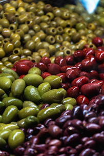 A display of olives and other fruits in a store
