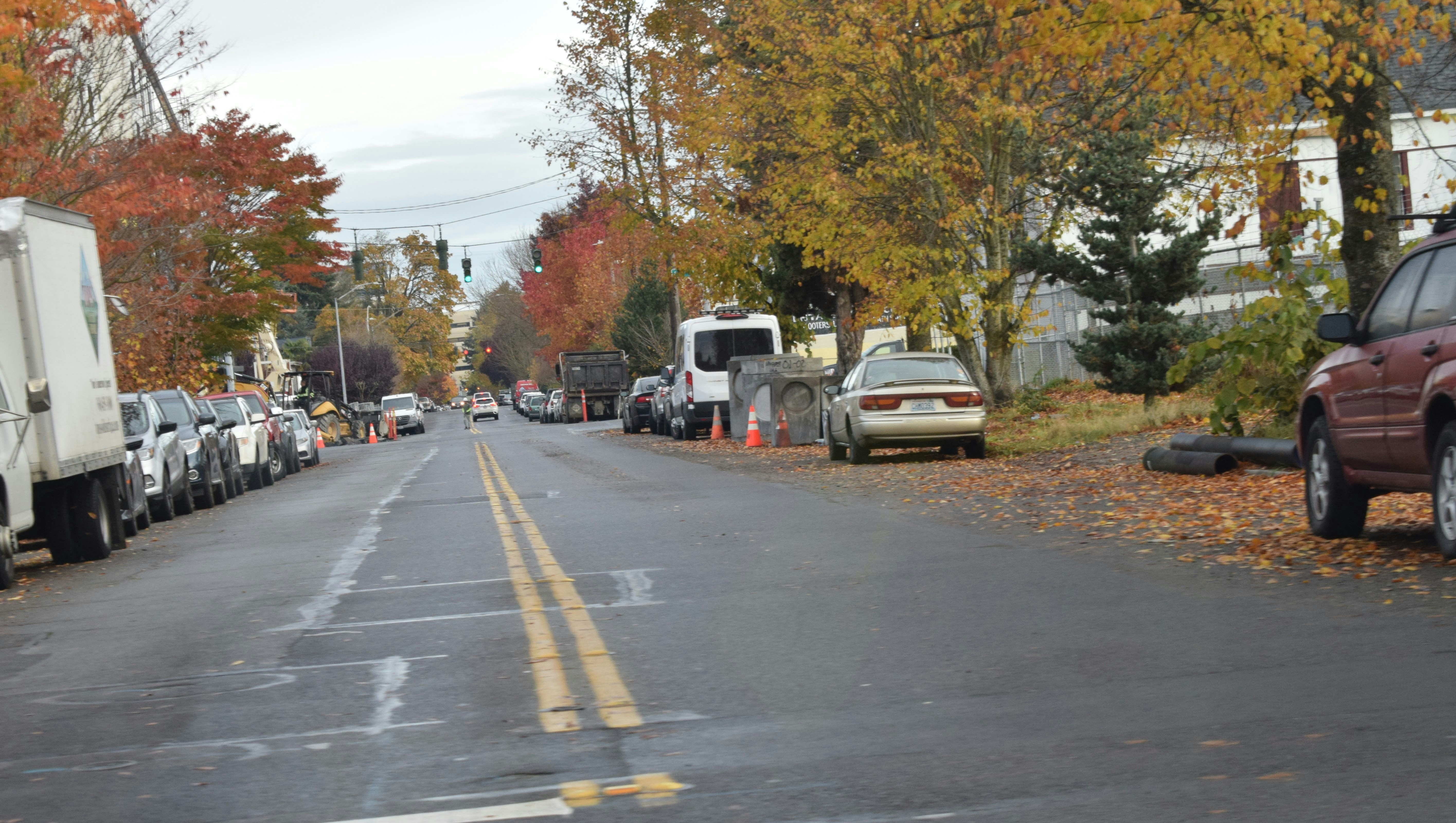 A street lined with parked cars and trees
