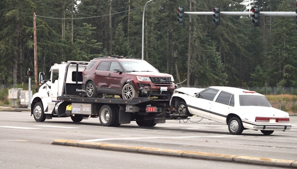 Tow truck towing a car on the road