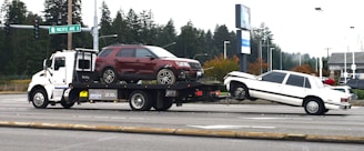 A tow truck towing a car on a flatbed