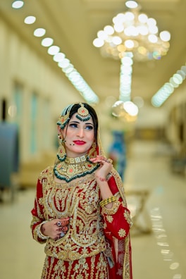 A woman in a red and gold bridal outfit