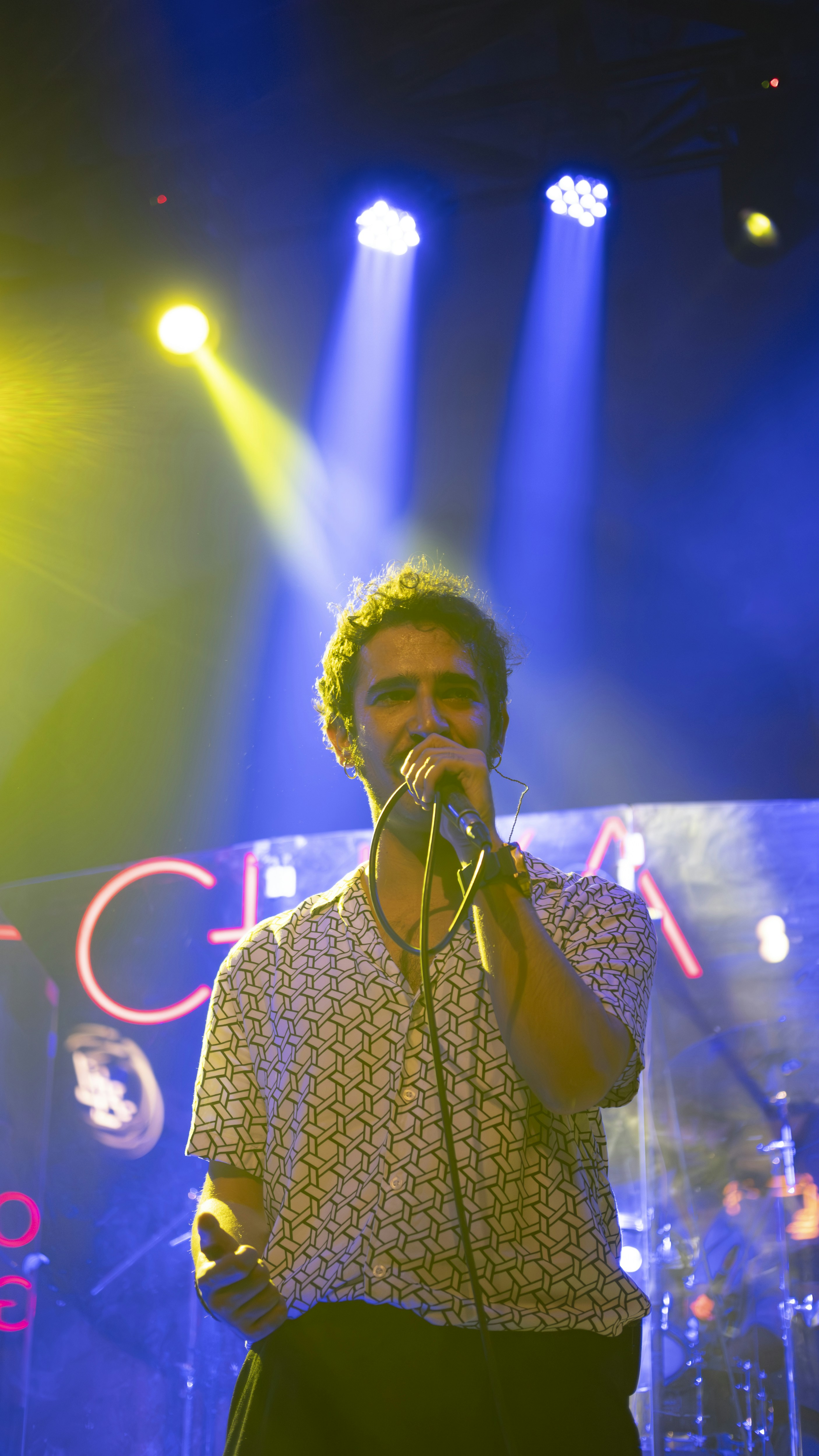 A man standing on a stage holding a microphone