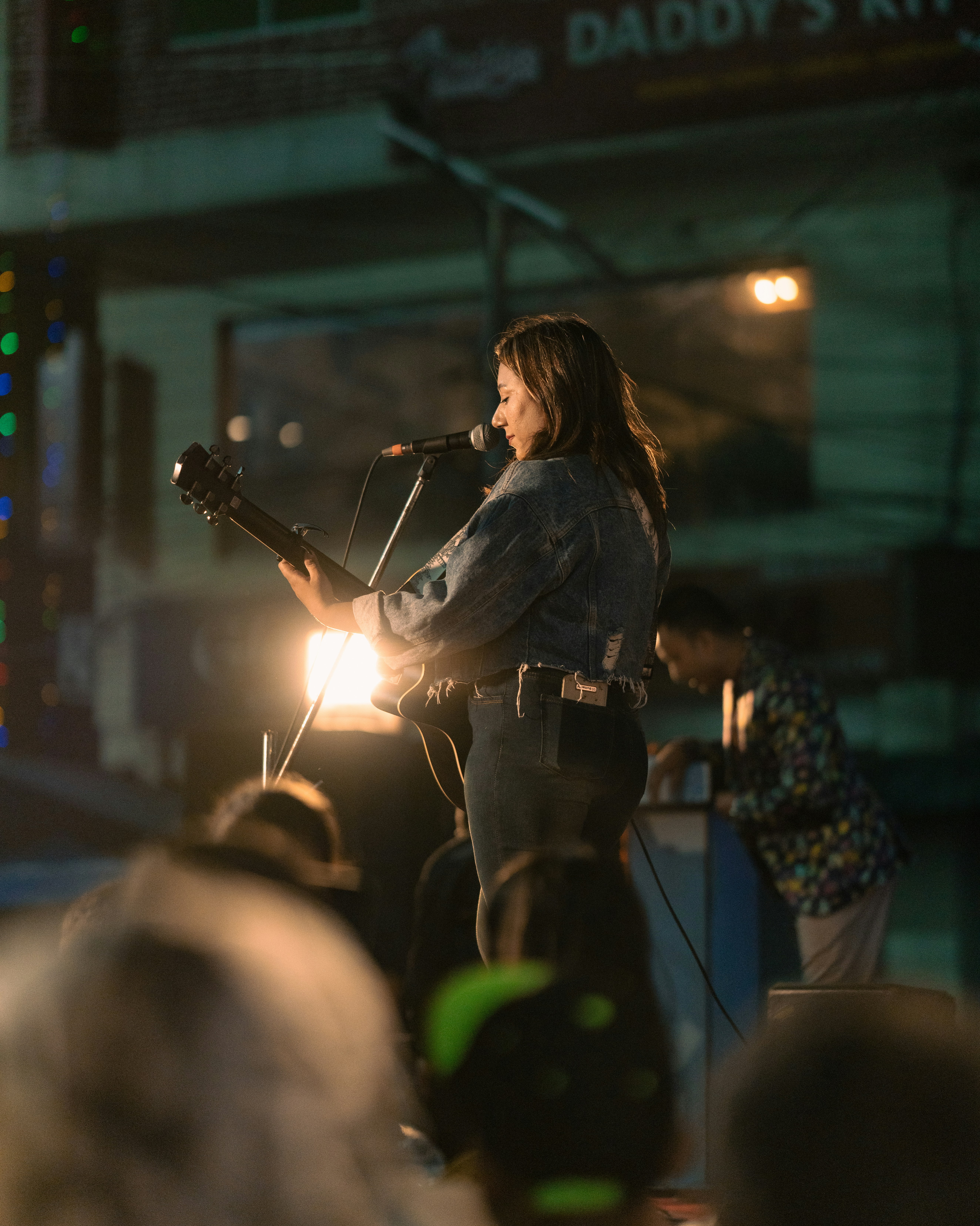 A woman standing on a stage with a microphone