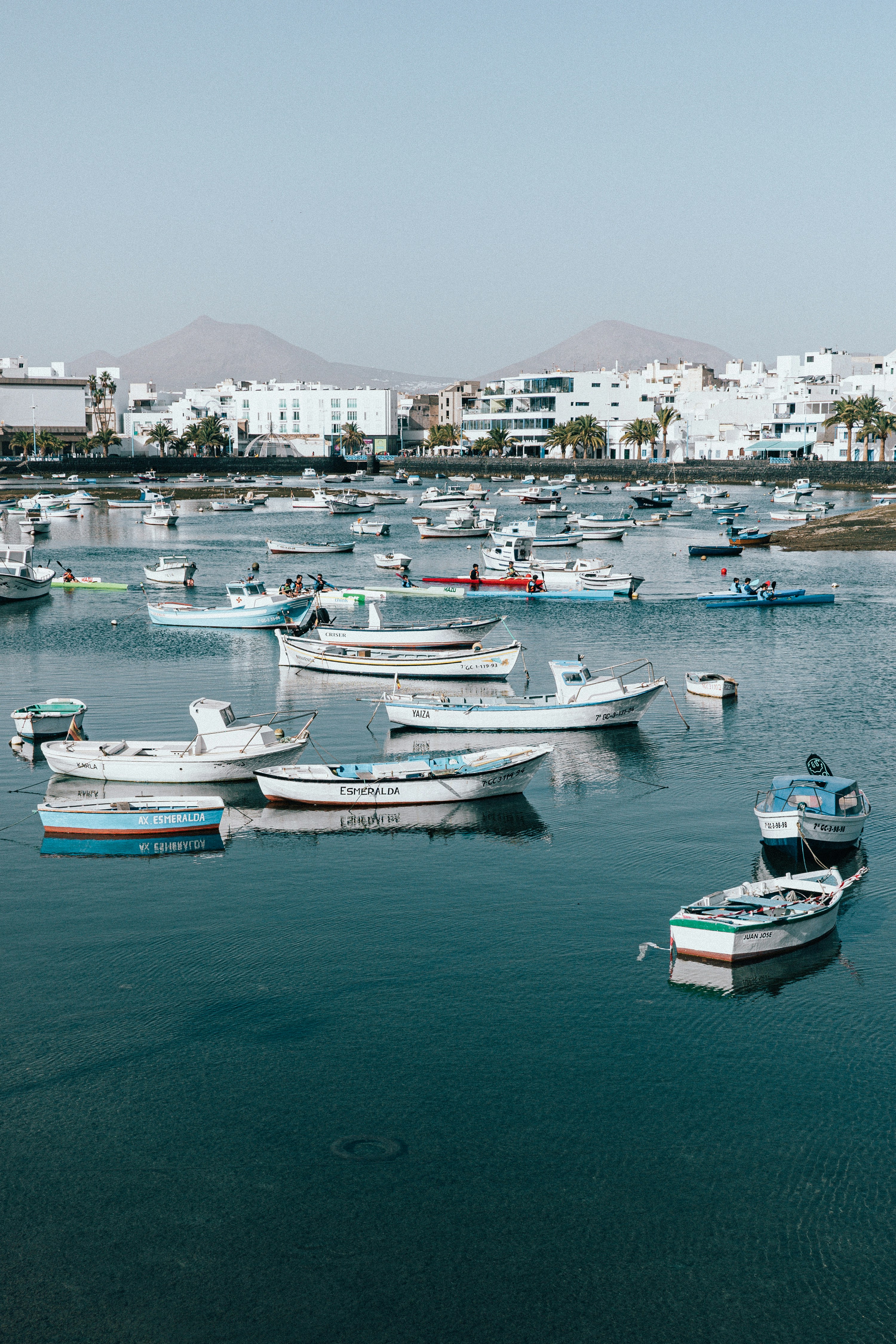 A group of boats floating on top of a body of water