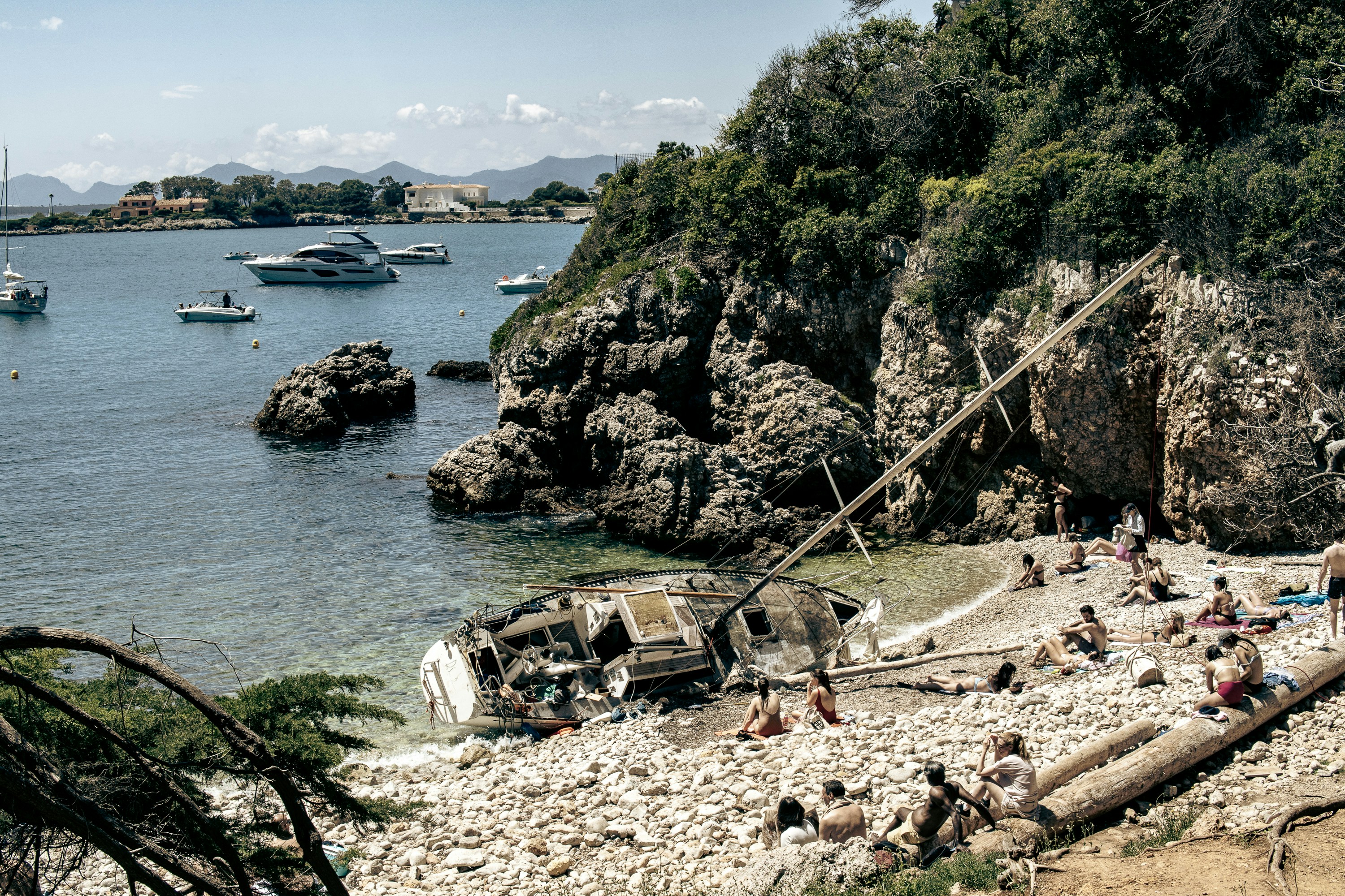 A group of people on a beach near a body of water