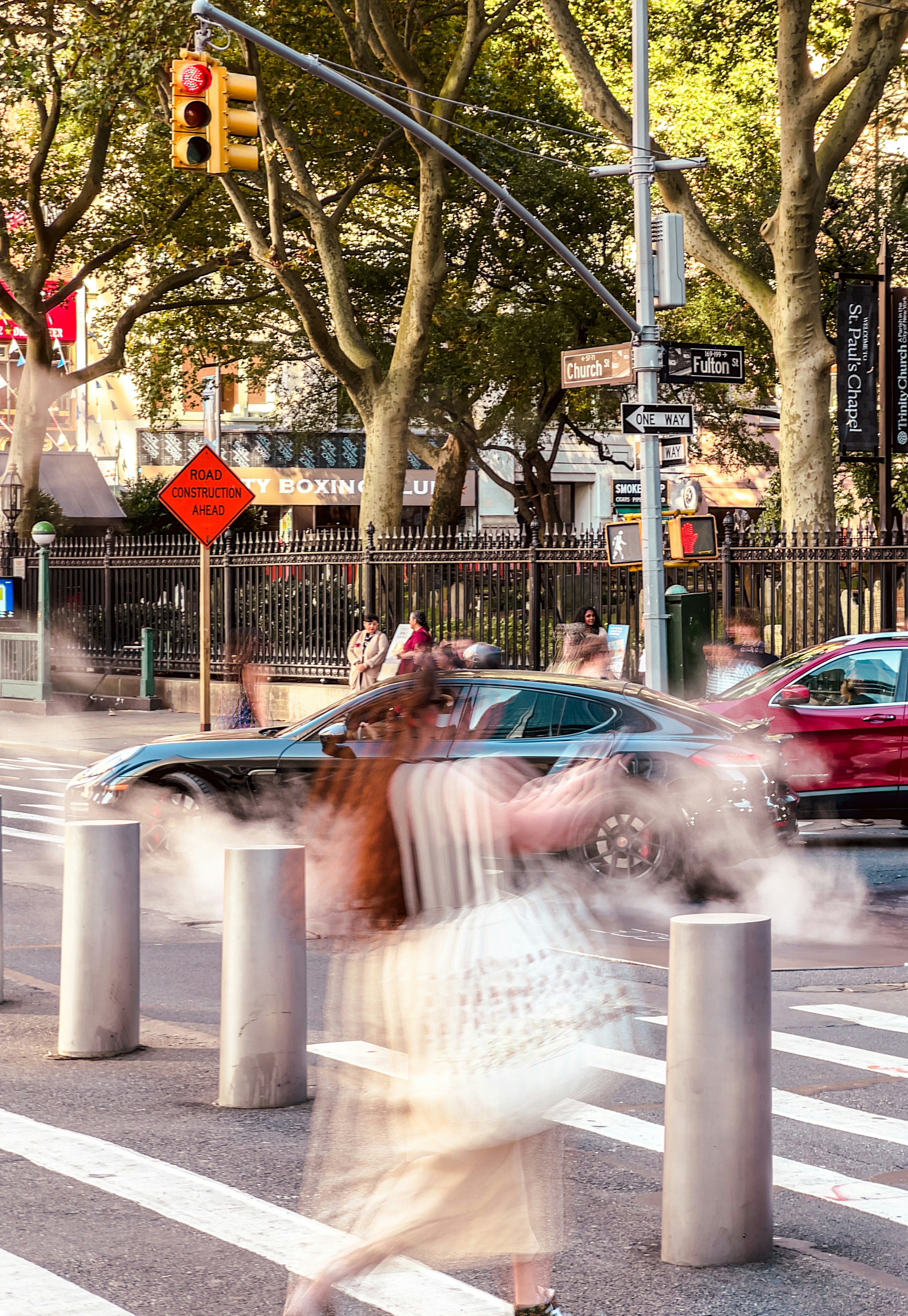 A blurry photo of a woman crossing the street