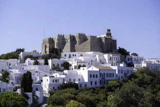 A white city with a castle on top of it
