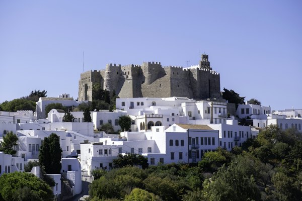 A white city with a castle on top of it — Patmos, Greece