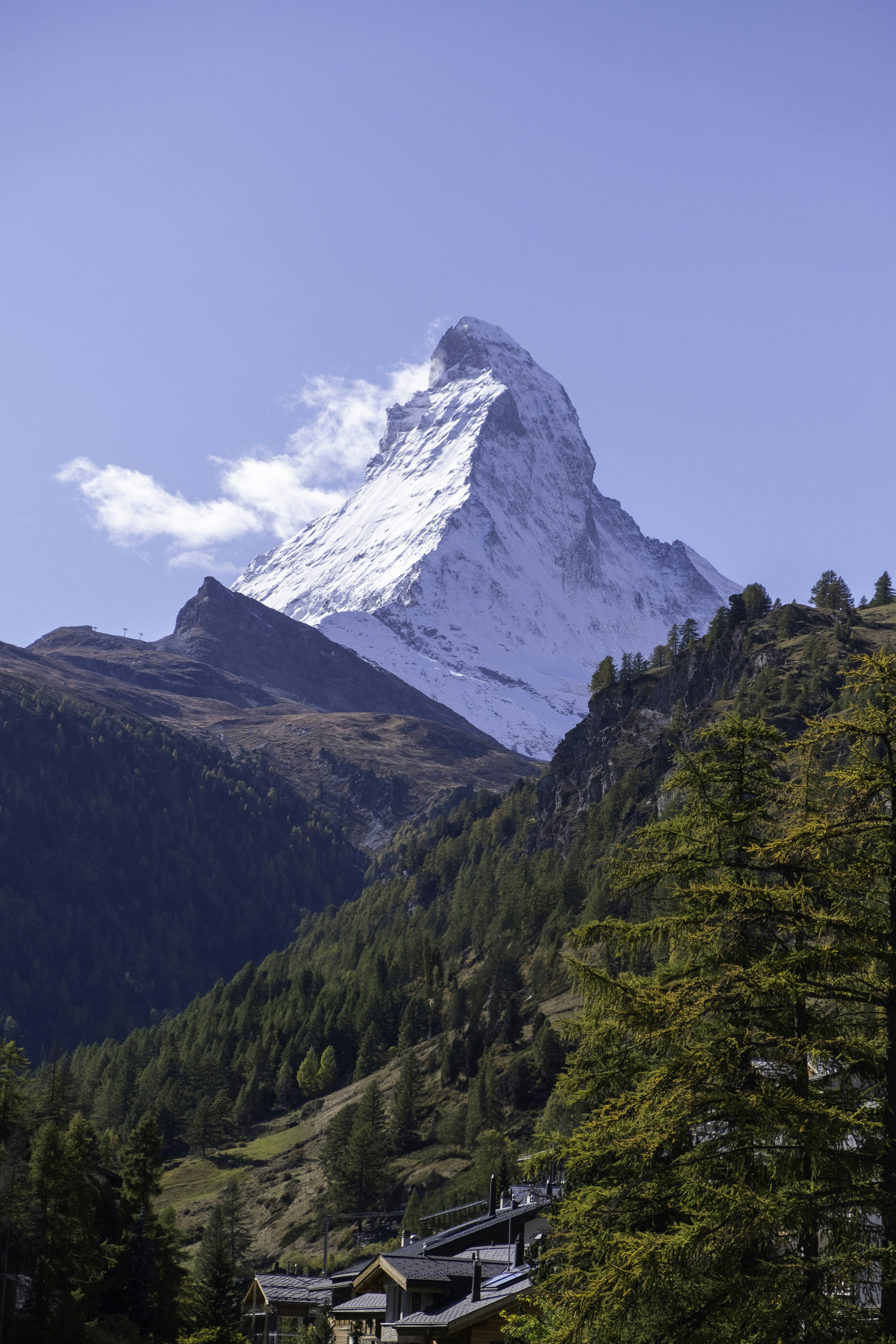 A mountain with a snow capped peak in the distance