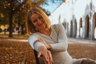 A woman sitting on a bench in a park